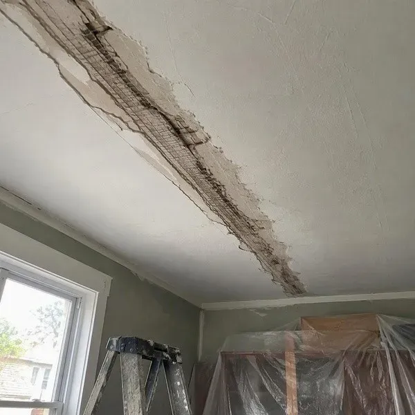 Ceiling crack prepared for repair with loose material removed