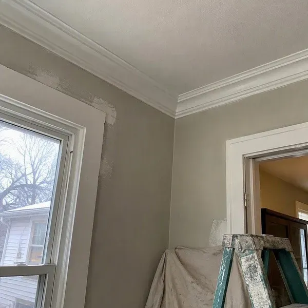 Repainted plaster crown moulding after corner repair