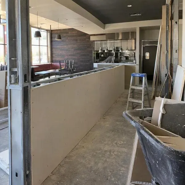 Restaurant renovation with partially boarded commercial drywall partitions